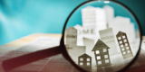 a magnify glasses is seeing through houses