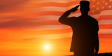 a veteran is saluting in sunrise